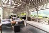Sofas and a hanging bench beneath the timber canopy at Gibraltar Gastrolounge, with mountain views outside.
