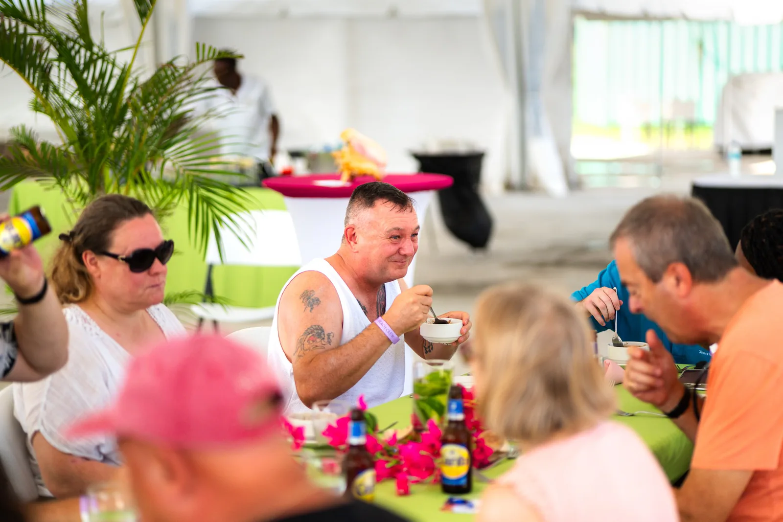 Foodie tour guests taste dishes together at a flower-decorated terrace table.