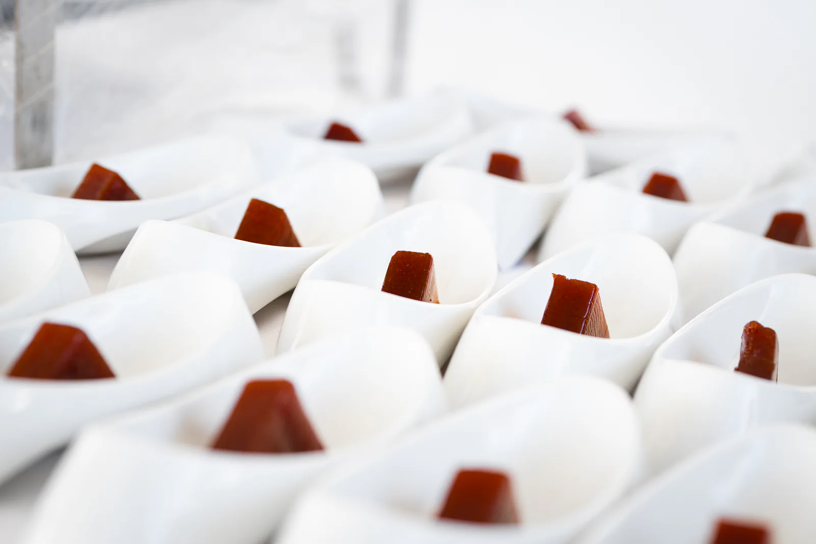 Small white bowls with bite-size brown sweets arranged for the Carambola food tour.