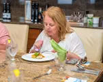 A foodie tour guest samples a small plate at the dining table in Carambola Beach Club.